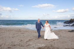 st ives cornwall wedding photography bride groom walking on beach